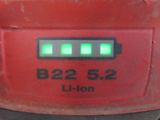 a close up of a red machine with a green light on it