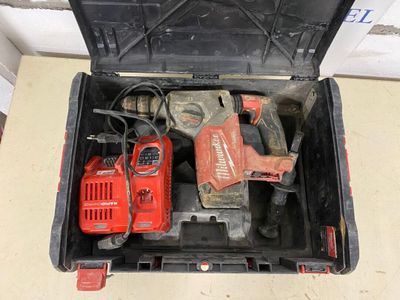a tool box with a drill and a hammer inside of it