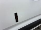 a remote control on the side of a white car