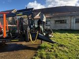 a tractor that is parked on the side of the road