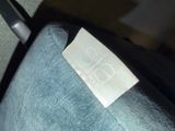 a label on the seat of a chair that is sitting on the floor