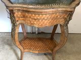 a wooden table with a glass top and a wicker shelf