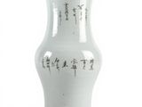 a white vase with asian writing on it on a white surface