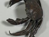 a metal crab that is sitting on a table