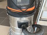 an orange and black vacuum cleaner sitting on top of a tiled floor