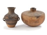 two vases sitting next to each other on a white surface