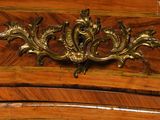 a close up of a wooden cabinet with a metal handle