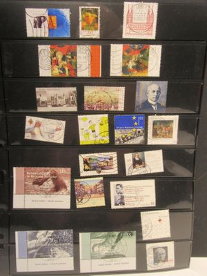 a black refrigerator with many different stamps on it