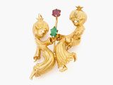 an image of a gold broochle with two cats and a flower