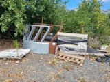 a pile of junk sitting on the ground next to some trees
