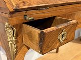 a wooden desk with a drawer on top of it