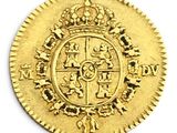 a close up of a gold coin with a crown on it