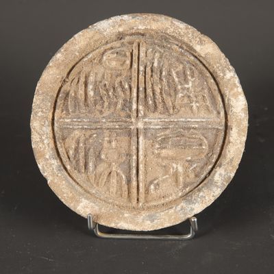 a close up of a stone object with a cross on it
