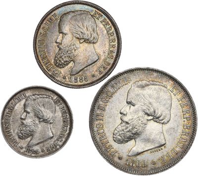 three different types of silver coins with a man ' s face and beard