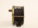 an old reel with a spool on it on a white background