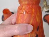 a person holding a vase with a flower inside of it