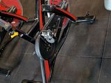 a row of stationary exercise bikes in a gym