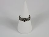 a close up of a ring on a cone on a white surface