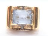 an image of a gold ring with a blue topaz stone