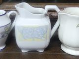 many different types of vases sitting on a shelf