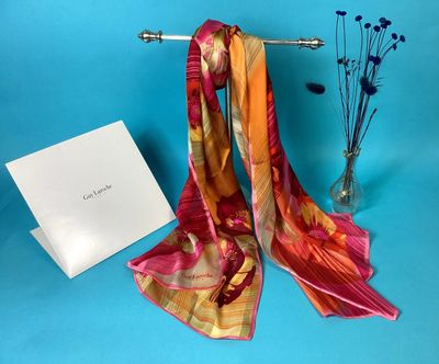 an image of a scarf and a card on a blue background