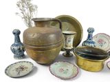 many different types of vases and plates on the table
