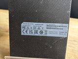 a close up of the back of a black and white cell phone