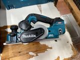 a picture of a corded planer sitting on a piece of wood