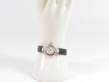 a white mannequin hand holding a watch on it ' s wrist
