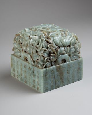 a sculpture of a box with a bunch of flowers inside of it