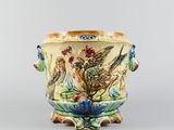 a vase with a bird and flowers on it