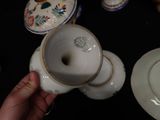 a person holding a cup and saucer on a table