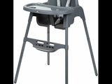 the high chair is gray and has a tray on it
