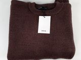 a close up of a brown sweater with a tag on it