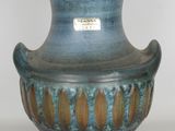 a blue vase with a brown design on it
