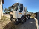 a white truck that is parked in the dirt