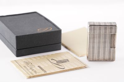 a silver lighter sitting next to a black box