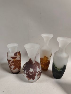 several vases with different designs are lined up on a white surface