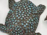 a turtle that is sitting on a table next to other figurines