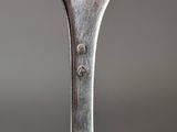 a silver spoon with a piece of food on it