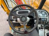 a steering wheel and dashboard of a construction vehicle