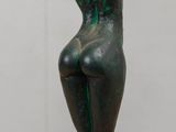 statue of a woman sitting on a pedestal with a vase in front of her