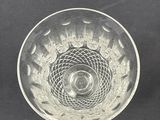 two clear glass bowls sitting on top of a black surface
