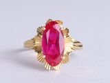 an image of a gold ring with a pink stone in the center