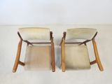 pair of mid - century modern chairs with upholstered cushions
