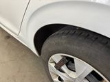 a close up of a tire on a car in a garage