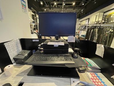 a laptop computer sitting on a desk in a store