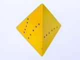 a yellow box with holes in it on a white surface