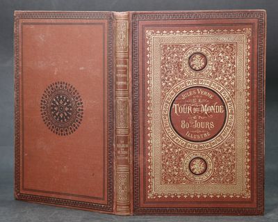 un vieux livre à la couverture rouge et à la bordure dorée