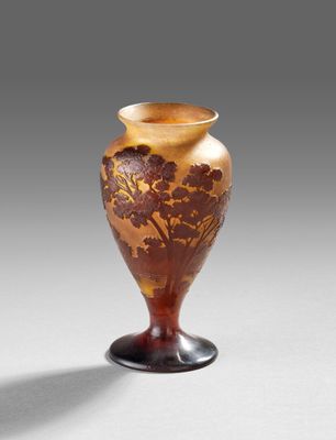 an old vase sitting on top of a table next to a white wall